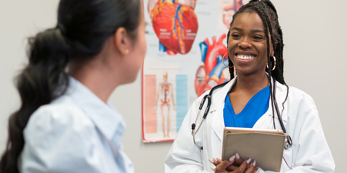 doctor explaining possible reasons you're spotting after a positive pregnancy test